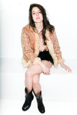 photography. Fashion editorial. Model wears a embroidered sheepskin jacket 