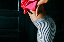 Photography. Fashion editorial. Bottom close up, with printed white leggings and pink silk jacket. 