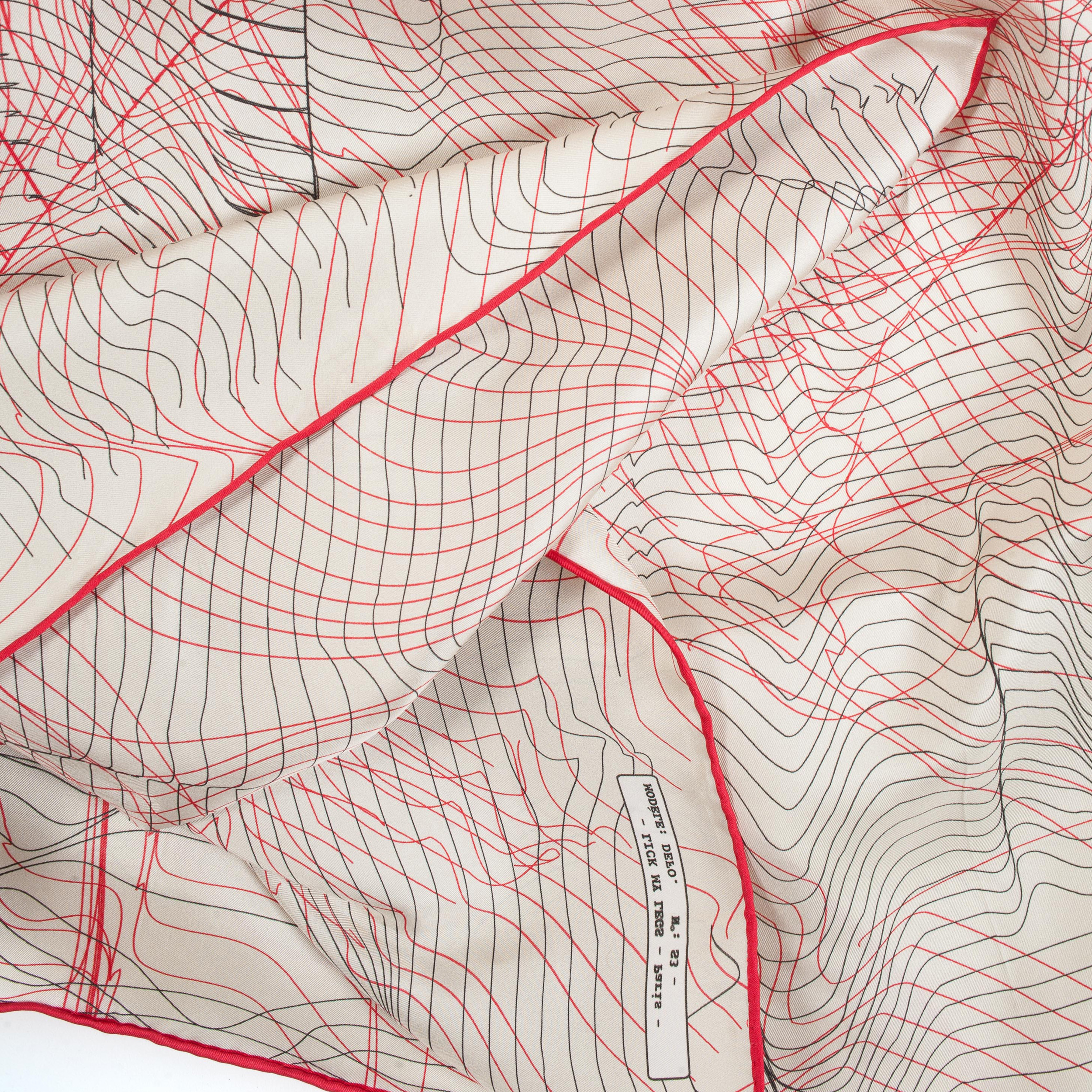 gros plan photo d'un carré en soie beige aux bordures rouges.